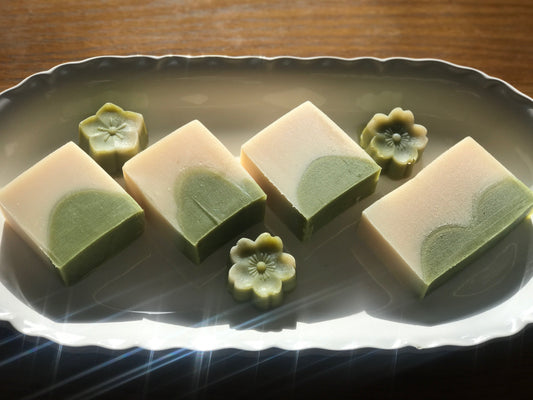 Lemon wheatgrass silk infused handmade soaps on plate.with flower shape mini soap